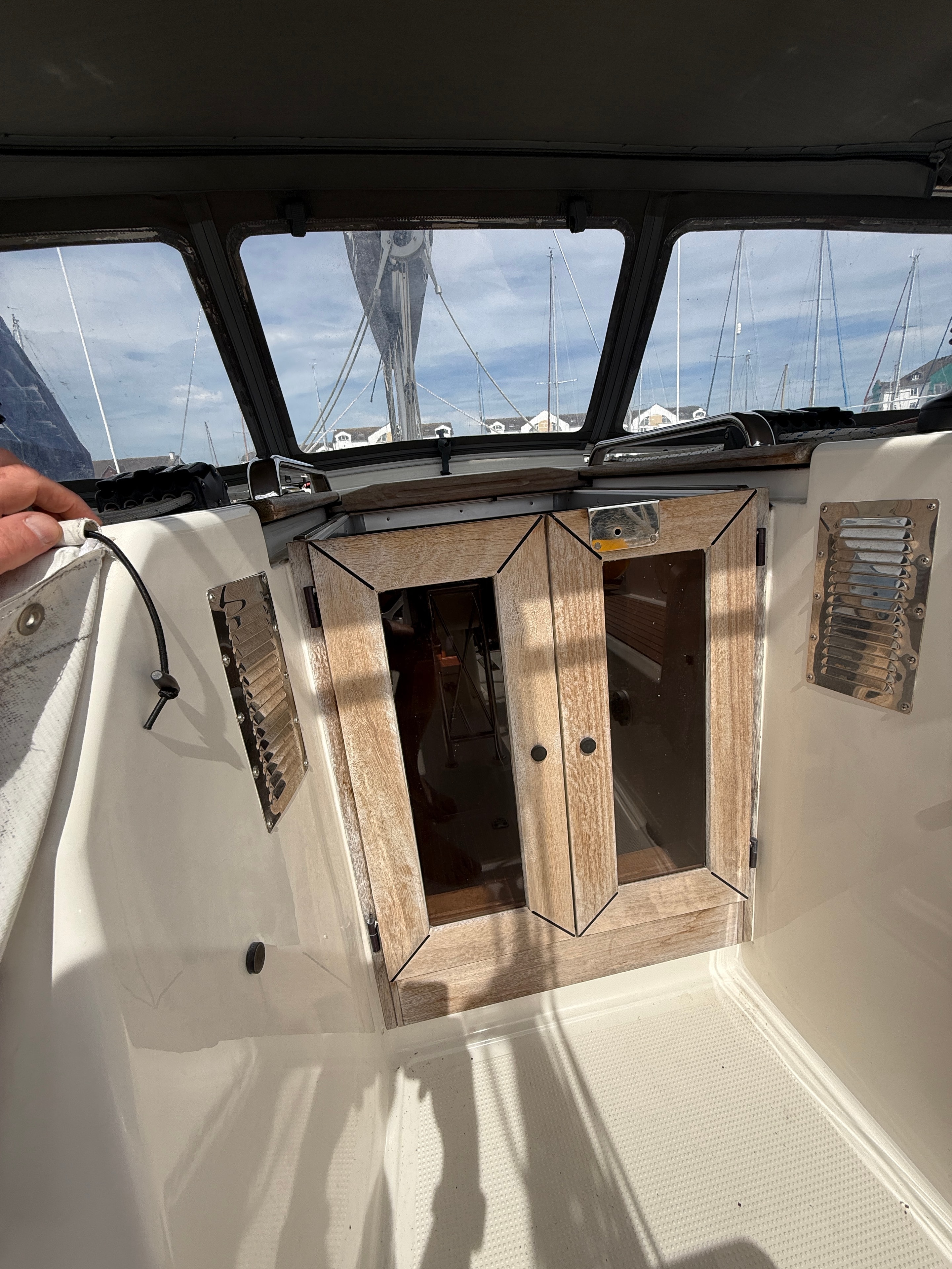 Cockpit doors closed — teak surround