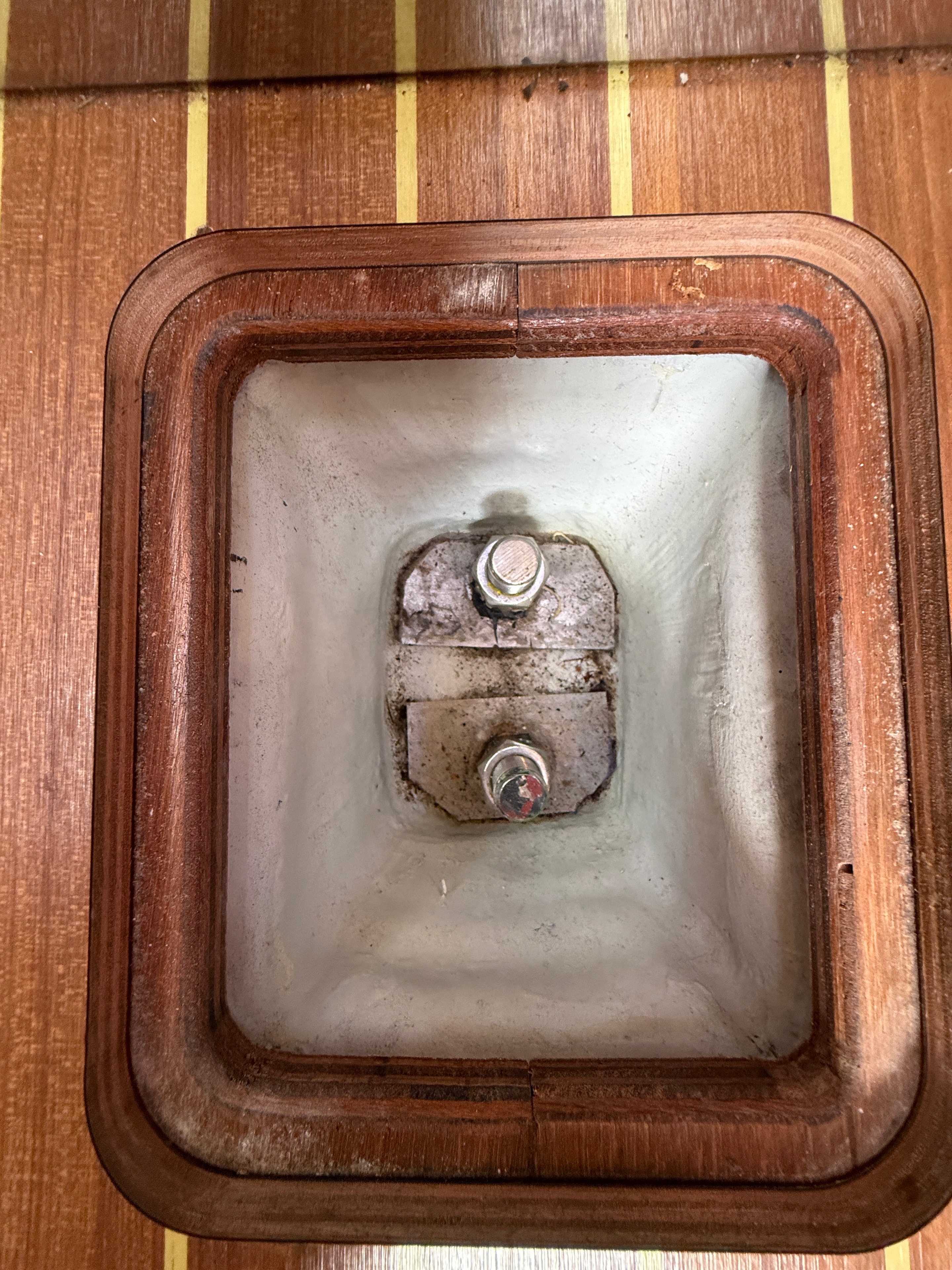 Keel bolts — inspection hatch open, stainless bolts through GRP sump