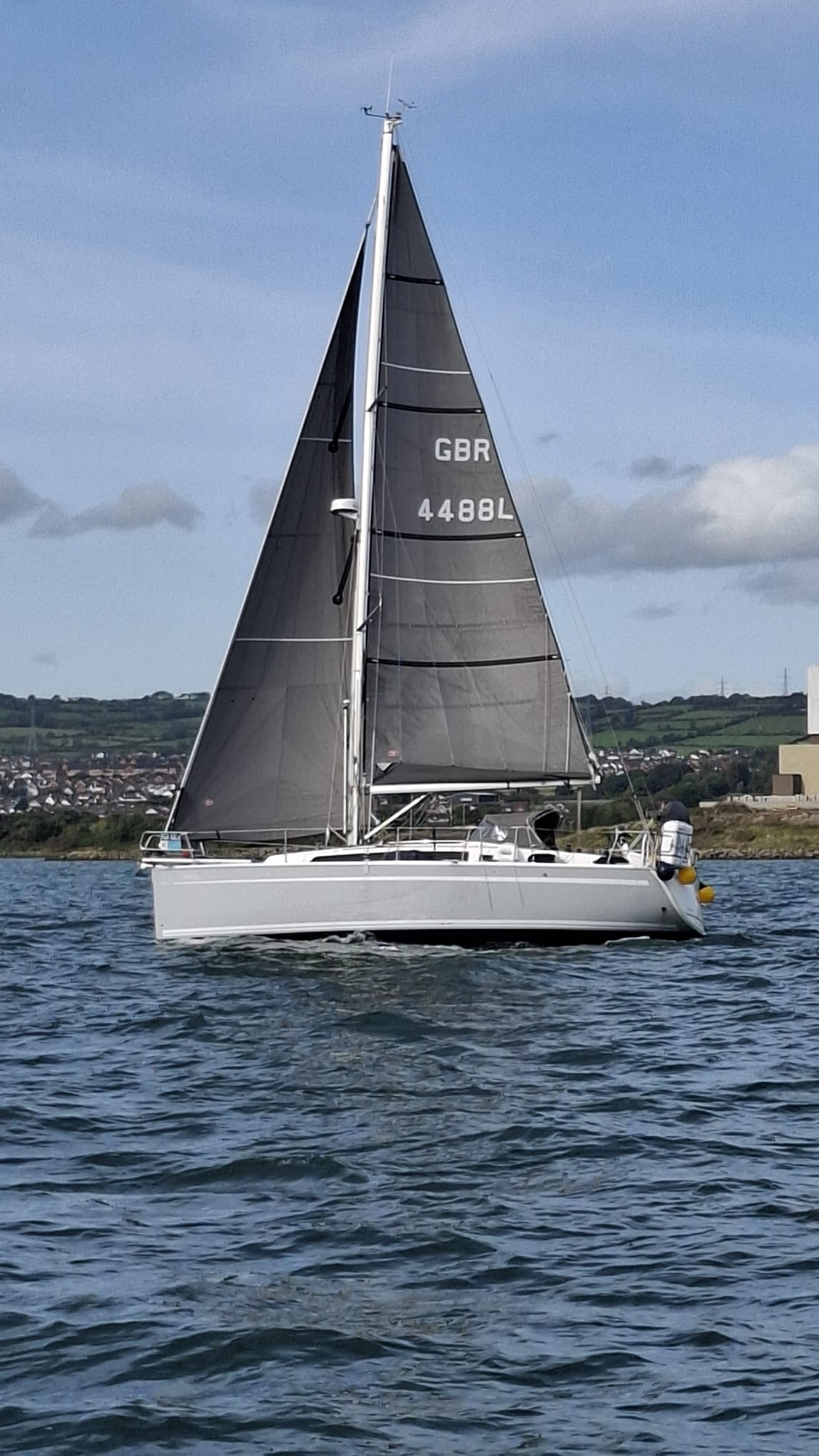 Teddy under sail — black Kemp mainsail, GBR 4488L, coastal waters